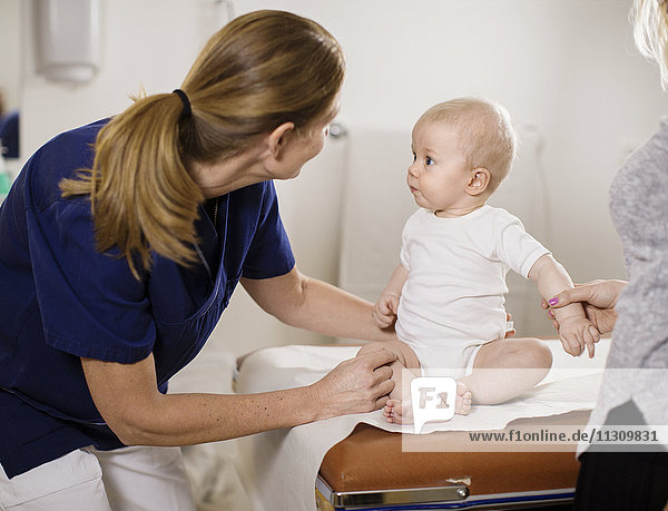 Doctor checking baby