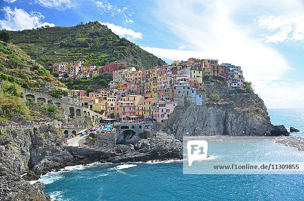 the beautiful and popular village of Manarola in the Cinque Terre  on Italy's Ligurian coast. On a bright sunny day.