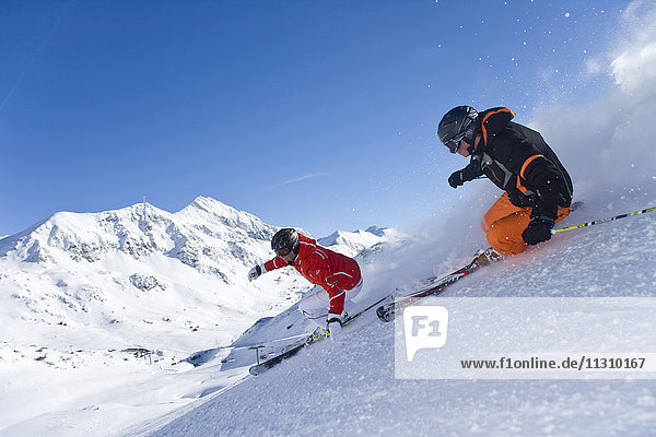 Österreich  Obertauern  Mann  Frau  Piste  Ski  Skifahren  Carving  Sport  Winter