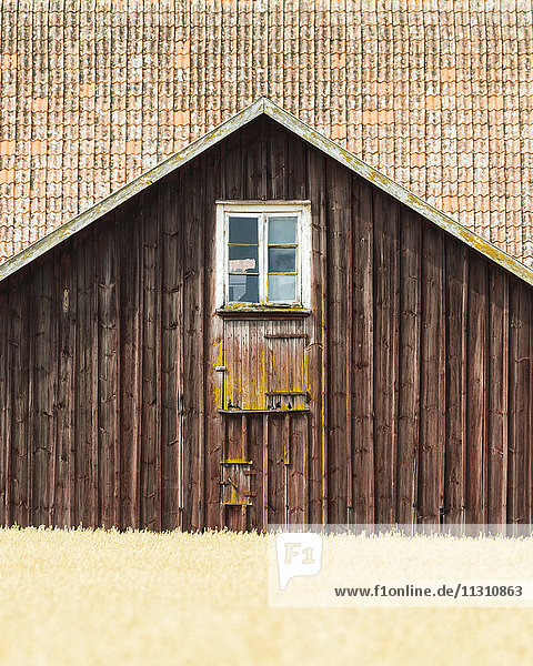 Wooden cottage in field