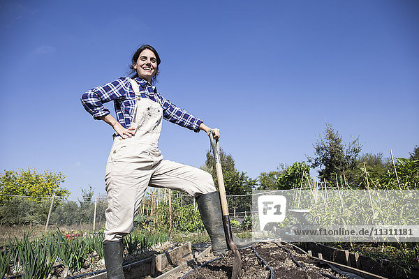 Woman working on farm  preparing vegetable patch