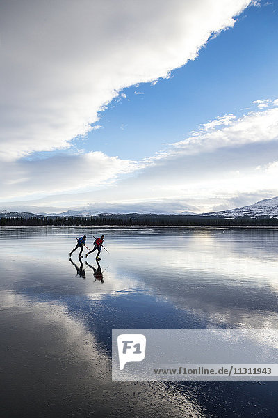 Two people moving on ice