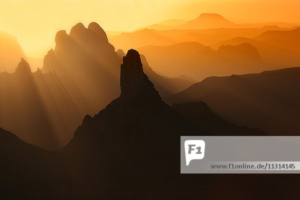 Algerien  Wilaya Tamanrasset  Hoggargebirge mit Vulkangestein bei Sonnenaufgang