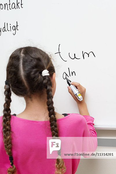Girl writing on whiteboard