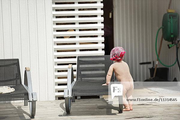 Baby standing on patio