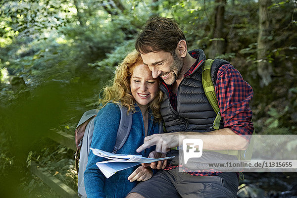 Hiking couple holding map