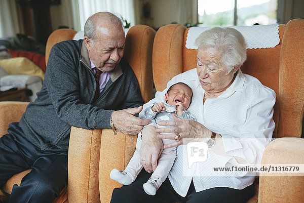 Great grandparents taking care of great granddaughter at home