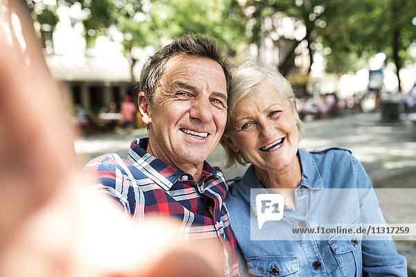 Senior couple taking selfie with smartphone