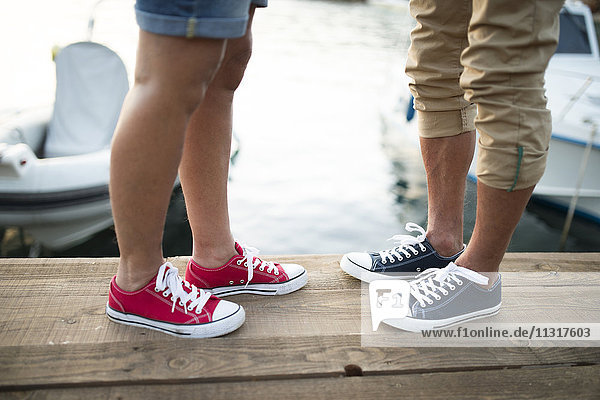 Senior couple wearing sneakers  partial view