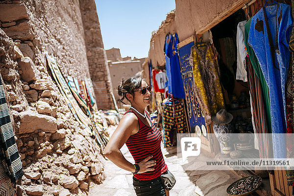 Morocco  Ouarzazate  tourist standing in front of clothing shop