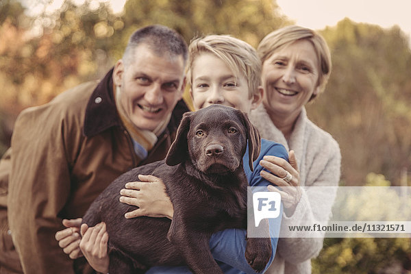 Portrait of family with Labrador Retriever