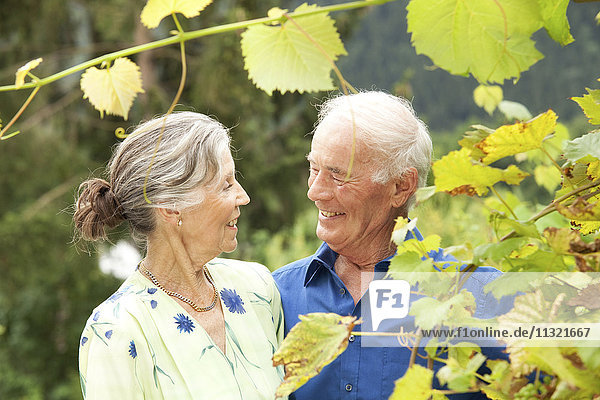 Confident senior couple standing in garden