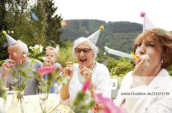 Seniors celebrating birthday oarty in garden