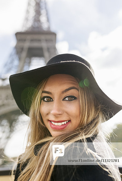 France  Paris  portrait of smiling woman in front of Eiffel Tower
