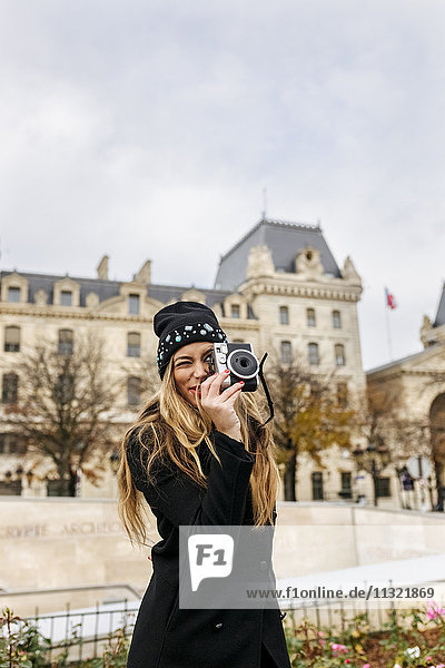 France  Paris  young woman taking picture with camera