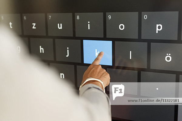 Businesswoman using projection of a keyboard