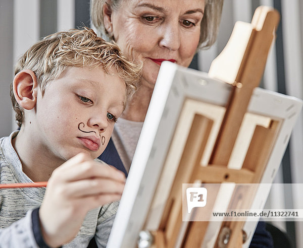Grandmother and grandson with Dali moustache at easel