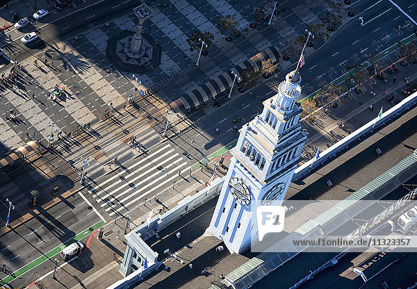 Aerial view of the Ferry Building in San Francisco  the clock tower and surrounding roads and waterfront.