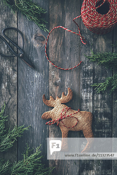Elchförmiges Weihnachtsgebäck auf dunklem Holz