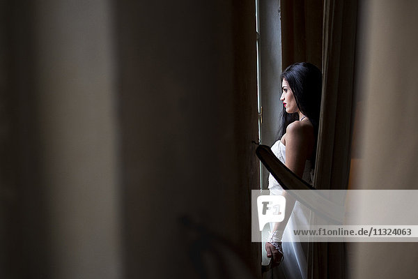 Bride looking out of window