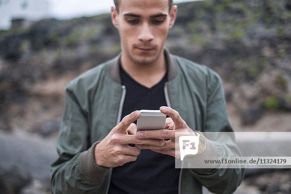 Young man reading text message