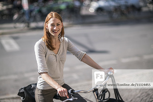 Porträt einer rothaarigen Frau mit Fahrrad