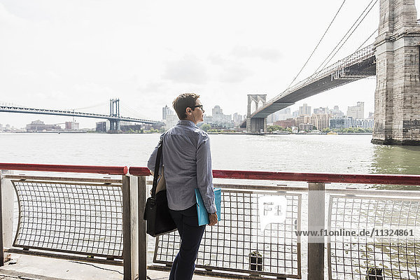 USA  New York City  woman standing at East River