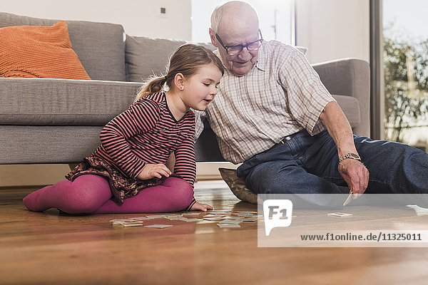 Grandfather and granddaughter playing memory