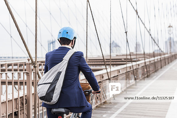 USA  New York City  Mann auf dem Fahrrad auf der Brooklyn Bridge