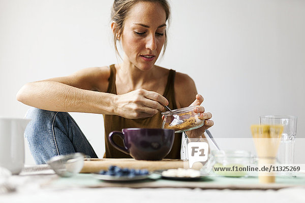 Woman preparing matcha latte at home