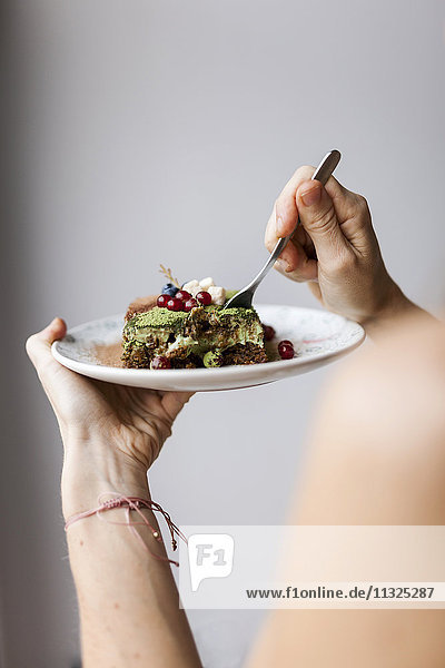 Woman eating vegan matcha cake