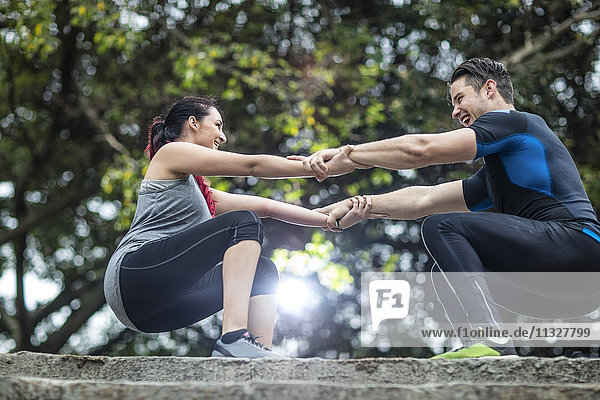 Young man and woman doing partner exercises