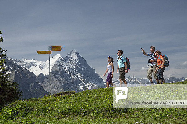 Hiker on Grosse Scheidegg in front of Eiger and monk in the Bernese Oberland  Switzerland