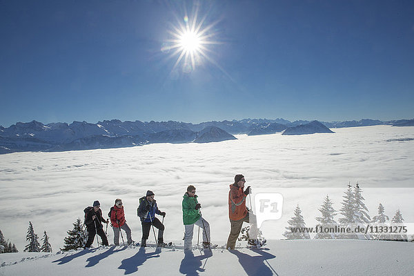 group doing snow shoe tour on Rigi mountain in winter in Central Switzerland