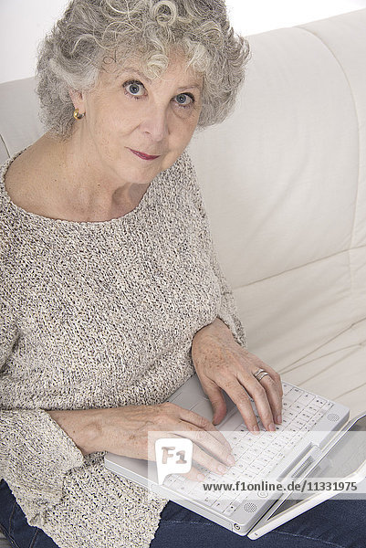 Senior woman using laptop.