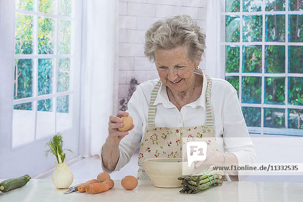 Ältere Frau beim Kochen.