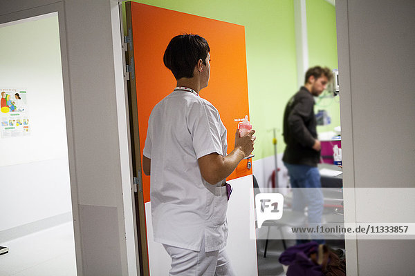 Reportage in the pediatric emergency unit in a hospital in Haute-Savoie  France. An auxiliary nurse brings a bottle of milk.