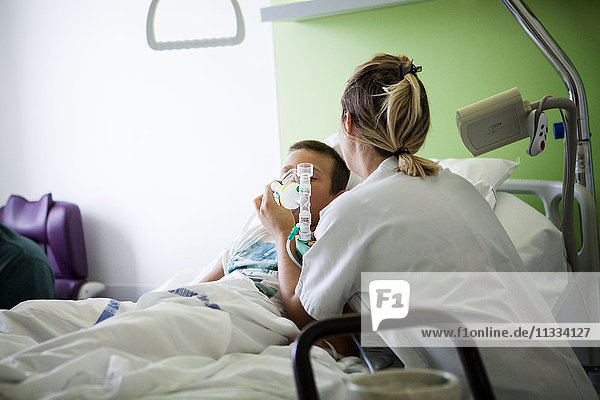 Reportage in the pediatric unit in a hospital in Haute-Savoie  France. A nurse gives Nitronox (a mix of gas and air) while a catheter is placed in a young patient.