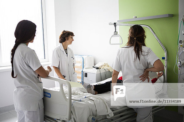 Reportage in the pediatric unit in a hospital in Haute-Savoie  France. A doctor  a junior doctor and an auxiliary nurse talk to a young patient.