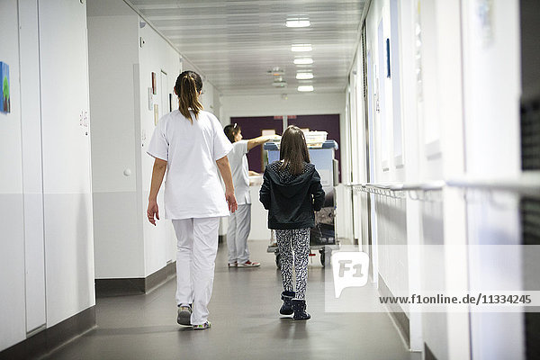 Reportage in the pediatric unit in a hospital in Haute-Savoie  France. An auxiliary nurse takes a young patient to the canteen.