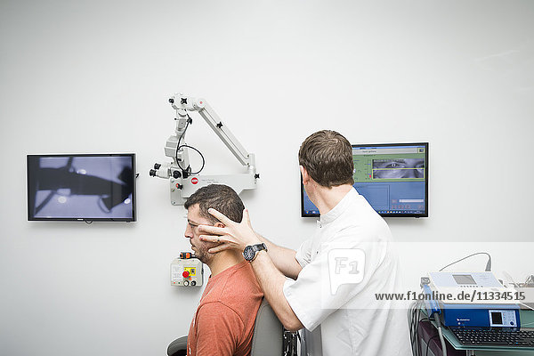 Reportage on an ENT doctor in Nice  France  treating patients suffering from dizziness. A 37-year old patient during a Video Head Impulse Test (VHIT). This test enables the reactivity of the inner ear during rapid head movements to be examined.