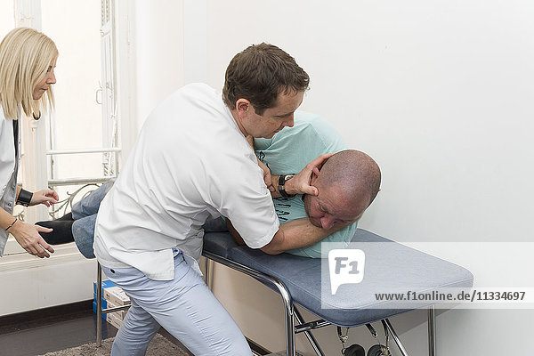 Reportage on an ENT doctor in Nice  France  treating patients suffering from dizziness. Treating benign paroxysmal positional vertigo (BPPV) manually in a patient. Treatment consists of a vestibular manipulation (the Semont or Epley manoeuvres at the most popular).