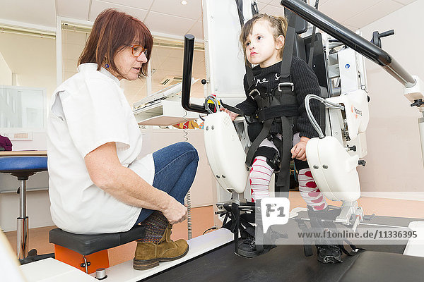 Reportage on the Rossetti health centre in Nice  France. This rehabilitation centre is a hub of excellence with cutting-edge technology. The Rossetti Motor Function Education Institute is the first French establishment to have a pediatric Lokomat PRO V6  an automated walking orthosis enabling intensive walking rehabilitation on a treadmill. This 4-year old girl suffers from neurological disorders and is late walking. She is having a training session with a physiotherapist.