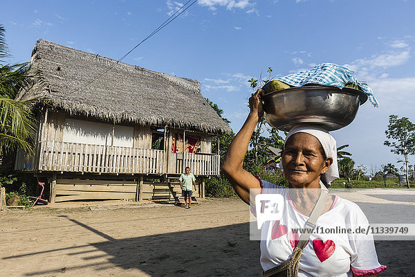Frau trägt Essen in Schüssel  San Miguel Caño  Oberes Amazonasbecken  Loreto  Peru  Südamerika
