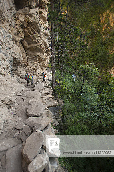 A trekking group makes their way into Dolpa beside the Suli Gadd between Chhepka and Amchi Hospital Nepal Asia