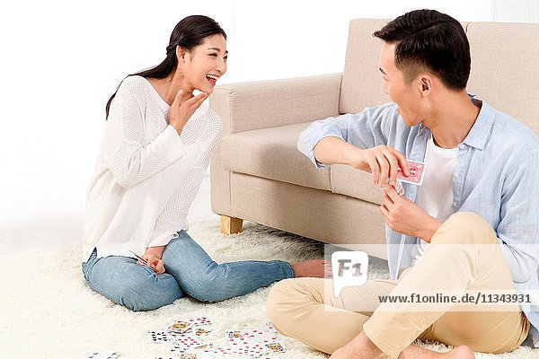 Young lovers playing cards