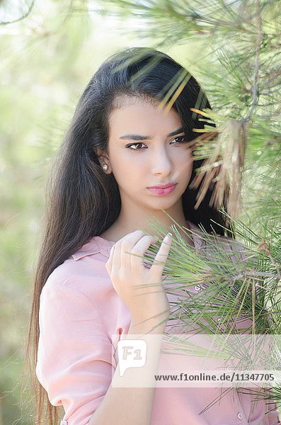 Beautiful young woman looking away outdoors.