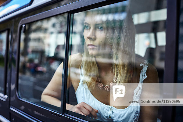 Young woman behind car window