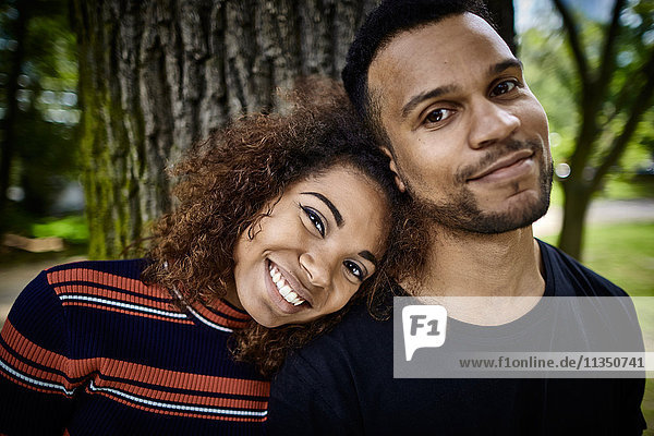 Portrait of smiling young couple in park