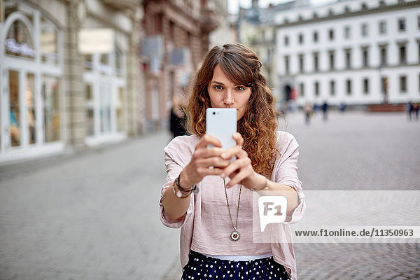 Young woman in the city taking a selfie
